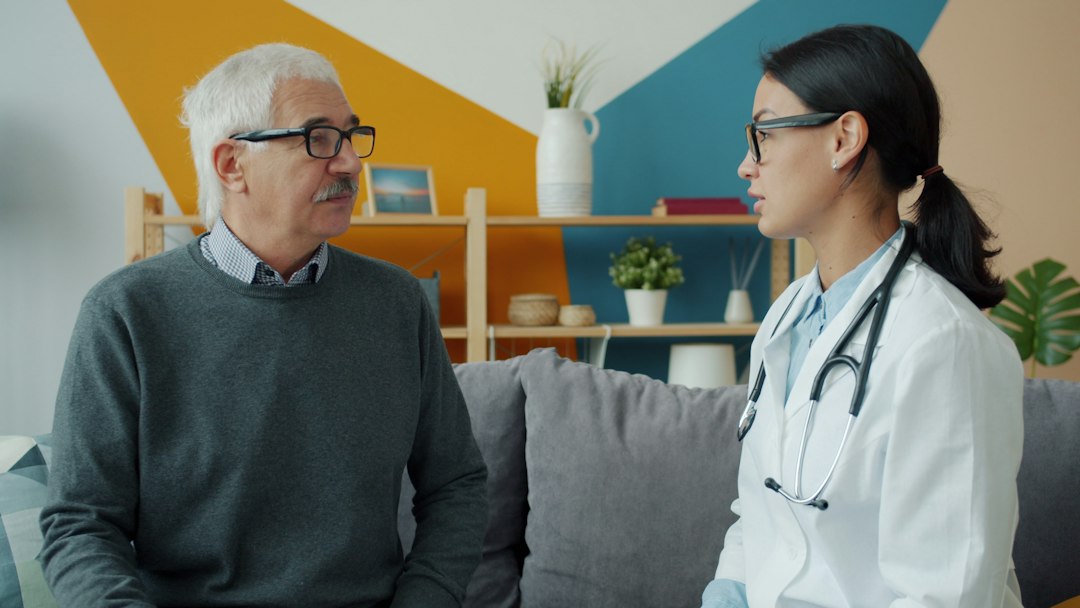 Doctor talking with a patient during a home consultation in Dubai